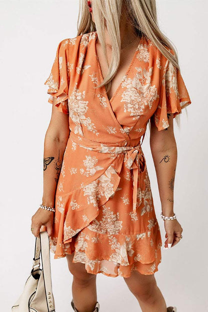 Woman wearing Floral Flutter Sleeve Tie Waist Ruffled Dress from Parnova.Store